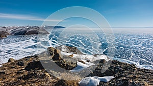 The frozen lake is covered with an openwork snow pattern.