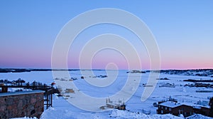 frozen lake covered with white snow at sunset