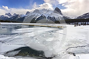 Frozen Lake and Distant Snowcapped Canadian Rocky Mountains Canmore Alberta