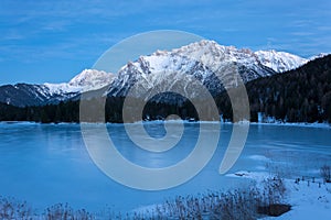 The frozen lake Lautersee near Mittenwald with snowy mountains