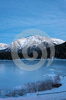 The frozen lake Lautersee near Mittenwald with snowy mountains