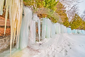 Frozen Lake Michigan island cliffs covered in sheets of frozen waterfalls