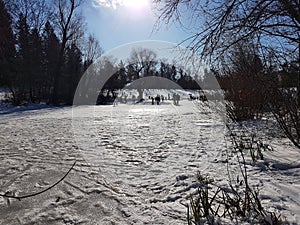 frozen lake with snow piste in a park in berlin, germany