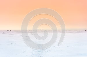 Frozen lake in winter white snow with wondrous orange sky landscape