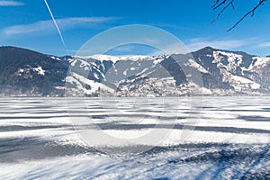 Frozen lake Zeller and snowy mountains in Austria