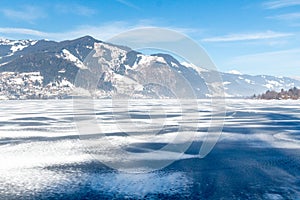 Frozen lake Zeller and snowy mountains in Austria