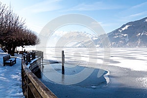 Frozen lake Zeller and snowy mountains in Austria