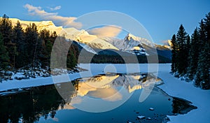 The frozen Maligne Lake with Queen Elizabeth Ranges in the background in the Jasper National Park