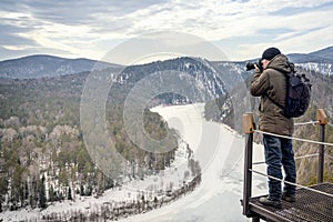 Frozen Mana River in Siberia during early spring. The travel photographer has expertly framed the beautiful winter