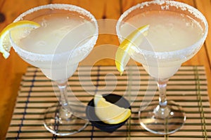 Frozen Margarita mixed drink with lime slice on plain background close up