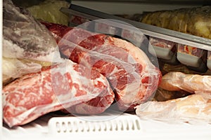 Frozen meat in the fridge close up view