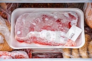 Frozen meat and other foods in the fridge freezer compartment