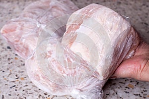 Frozen meat on the table. Refrigerator with frozen food