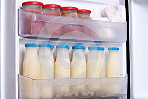 Frozen milk on the freezer shelf photo