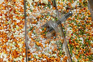 Frozen mixed vegetables in a refrigerator in a supermarket. Healthy eating and processed foods. Close-up. Top view. Background