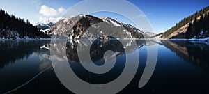 Frozen mountain lake pano