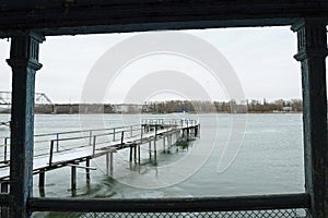 Frozen old pier at river side.