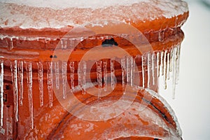 Frozen orange Fire Hydrant after an ice storm