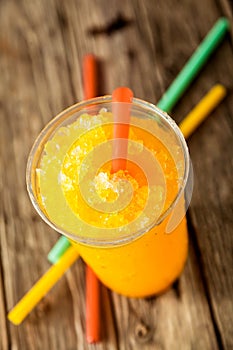 Frozen Orange Slushie in Plastic Cup with Straw