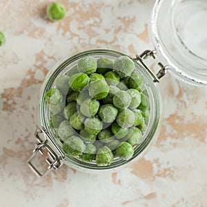 Frozen peas in a glass jar. Freezing is a safe method of increasing the shelf life of nutritious foods