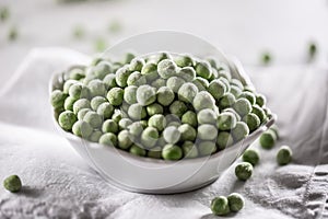 Frozen peas in a white porcelain bowl