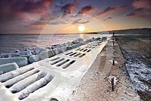 Frozen pier in the sunset