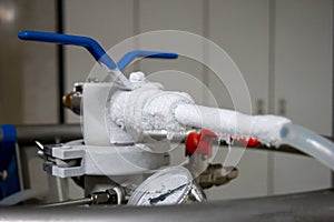 Frozen pipes and valves on high pressure nitrogen tank in a science lab