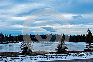 Frozen ponds with a skiff of snow. Sibbald Creek Trail, Alberta, Canada