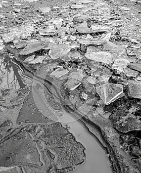 Frozen puddles on a dirt road. Nature in winter