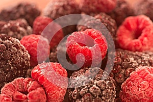 Frozen raspberries and blackberries on plate