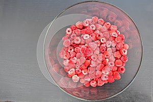 Frozen raspberries on grey