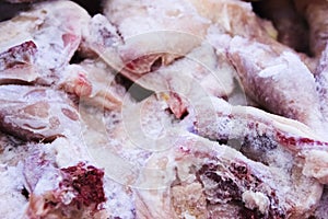 Frozen raw chicken, background macro view from above