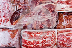 Frozen raw meat wrapped on a box in the freezer