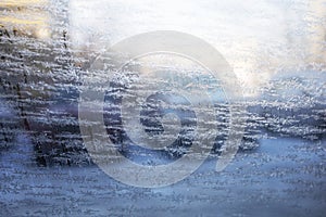 Frozen rear-view mirror. frosted car glass. snow covered car windshield. view from inside the car in city.