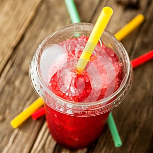 Frozen Red Slushie in Plastic Cup with Straw