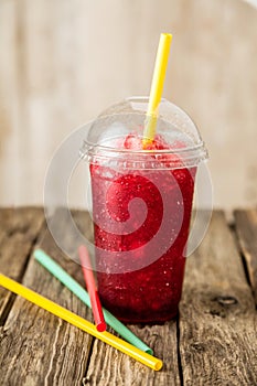 Frozen Red Slushie in Plastic Cup with Straw