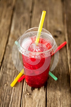 Frozen Red Slushie in Plastic Cup with Straw