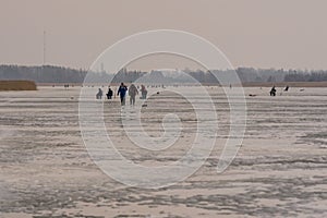 Frozen river, bent and icy anglers