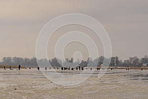 Frozen river, bent and icy anglers