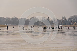 Frozen river, bent and icy anglers