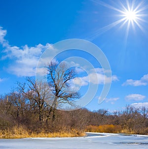 frozen river covered by snow at sunny day