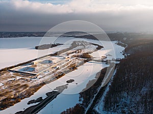 Frozen river and island, aerial or top view from drone of winter landscape with snow and lake or river in ice