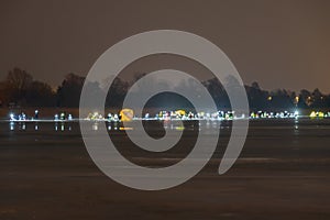 Frozen river, night and ice anglers