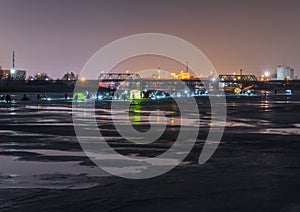 Frozen river, night and ice anglers