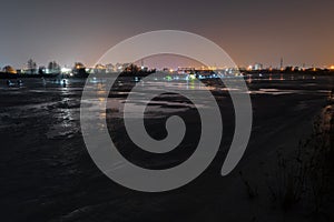 Frozen river, night and ice anglers