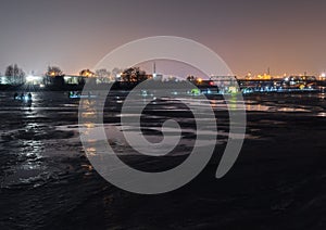 Frozen river, night and ice anglers