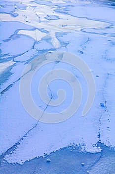 Frozen river sea on dike snow ice floes black ice