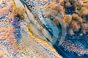 Frozen river in spring in countryside. Aerial landscape at sunrise