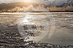 Frozen river with sun glow