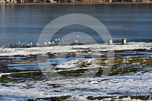 Frozen river in sunny winter day